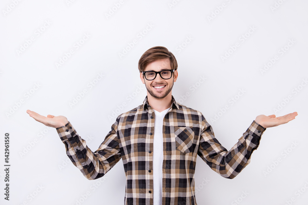Happy smart young worker in glasses making presentation of two different options Happy smart young worker in glasses making presentation of two different options