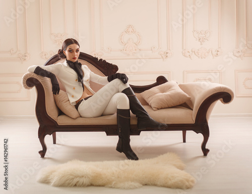 Valokuva Strict, beautiful girl in elegant rider suit poses on camera
