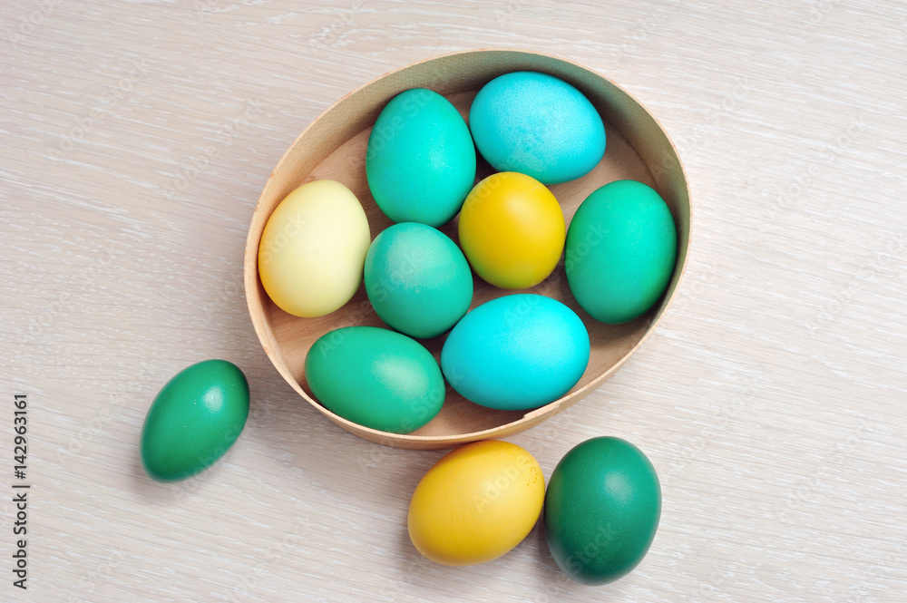 colorful eggs as symbol of Easter in box on wooden background colorful eggs as symbol of Easter in box on wooden background