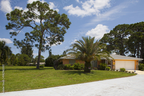 Obraz na płótnie Luxury family house with landscaping on the front and blue sky on background w salonie