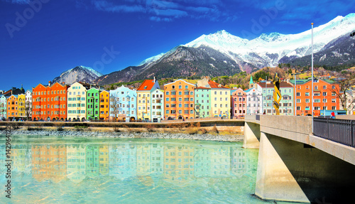 City scape in Innsbruck city center with beautiful houses, river Inn and Tyrolian Alps, Austria, Europe.