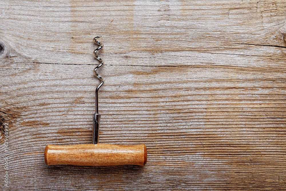 Corkscrew on a wooden background