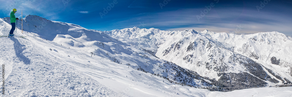 Man enjoying the stunning view before freeride skiing in famous ski resort in Tyrolian Alps, Zillertal, Austria
