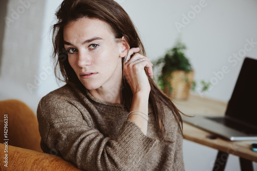 indoor portrait of beautiful feminine thoughtful young women alone in the room.