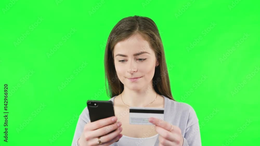 Young woman online shoping with bank cards a phone on green screen background. Young woman online shoping with bank cards a phone on green screen background.