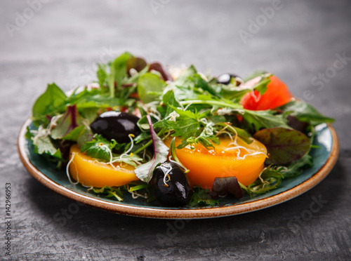 Fresh Green mix Salad with Vegetables, Tomatoes and Microgreen.Leaves Of Spinach,Arugula,Romaine,Lettuce.Concept of Healthy Food.Vegetarian.Copy space for Text. selective focus. photo