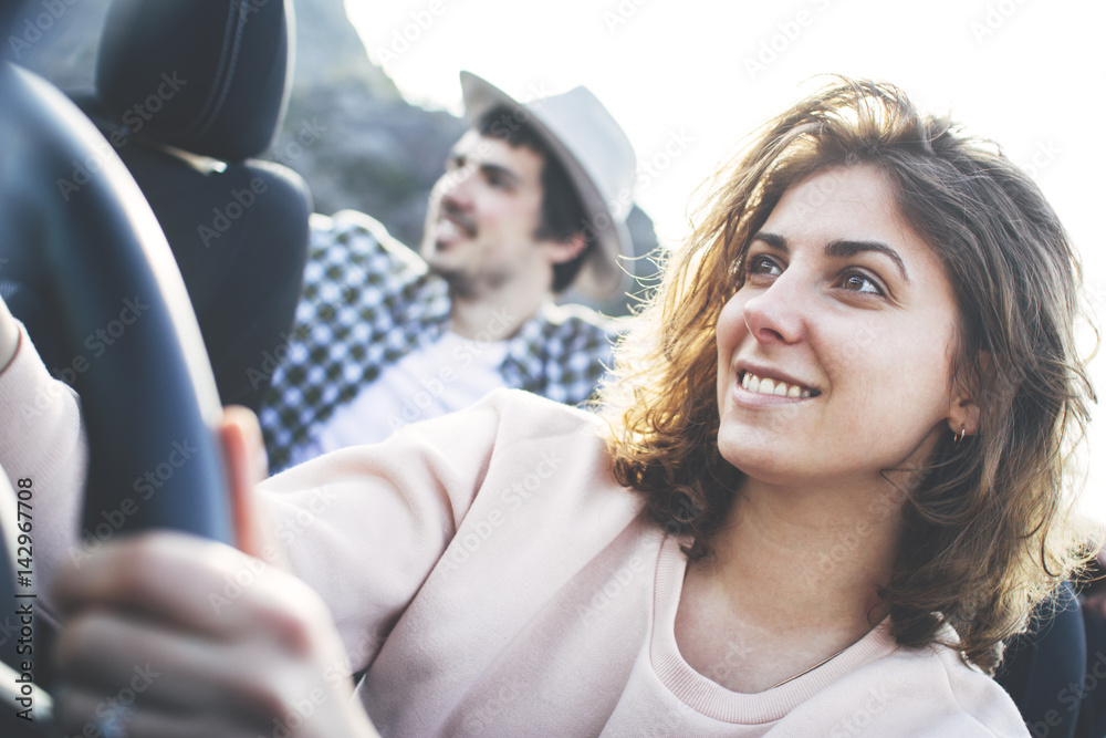 Beautiful girl sits at the wheel of a cabriolet and in the back seat sits her friend Beautiful girl sits at the wheel of a cabriolet and in the back seat sits her friend