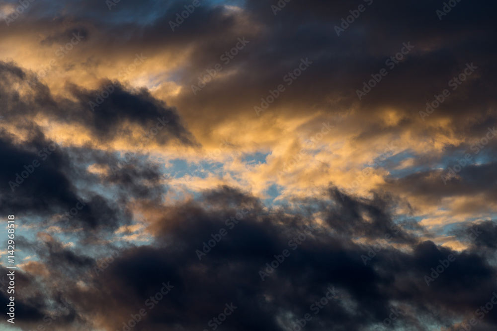 Abstract dramatic sky background with fluffy sunset clouds, cloudscape pattern, copy space