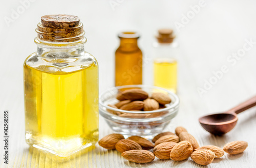 spa with almond oil in organic cosmetic set on white background