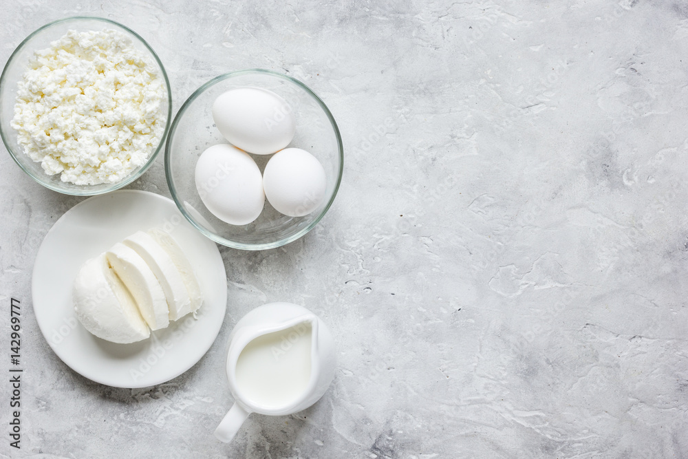 Fresh dairy products on stone table background top view mock up Fresh dairy products on stone table background top view mock up