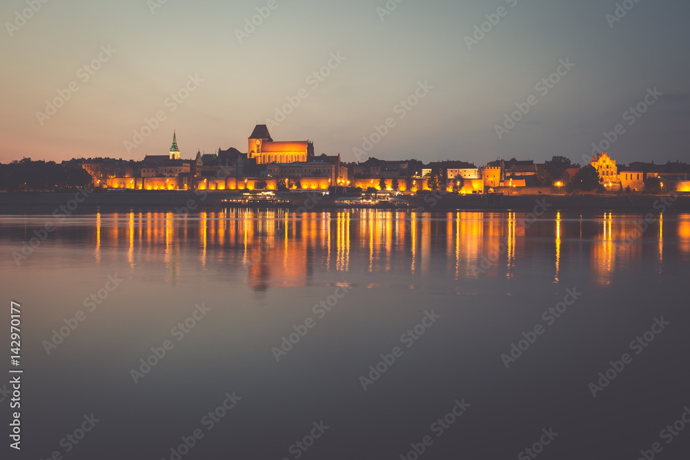 Fototapeta premium City of Torun in Poland, old town skyline by night from Vistula river