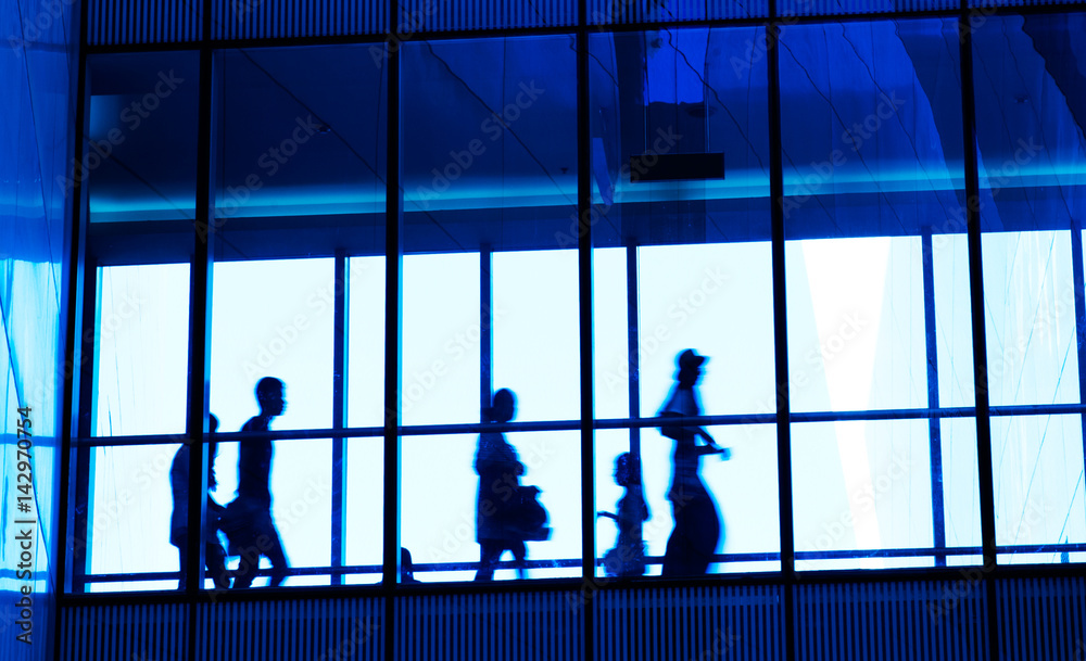 silhouettes of business people rushing at morden office building. silhouettes of business people rushing at morden office building.