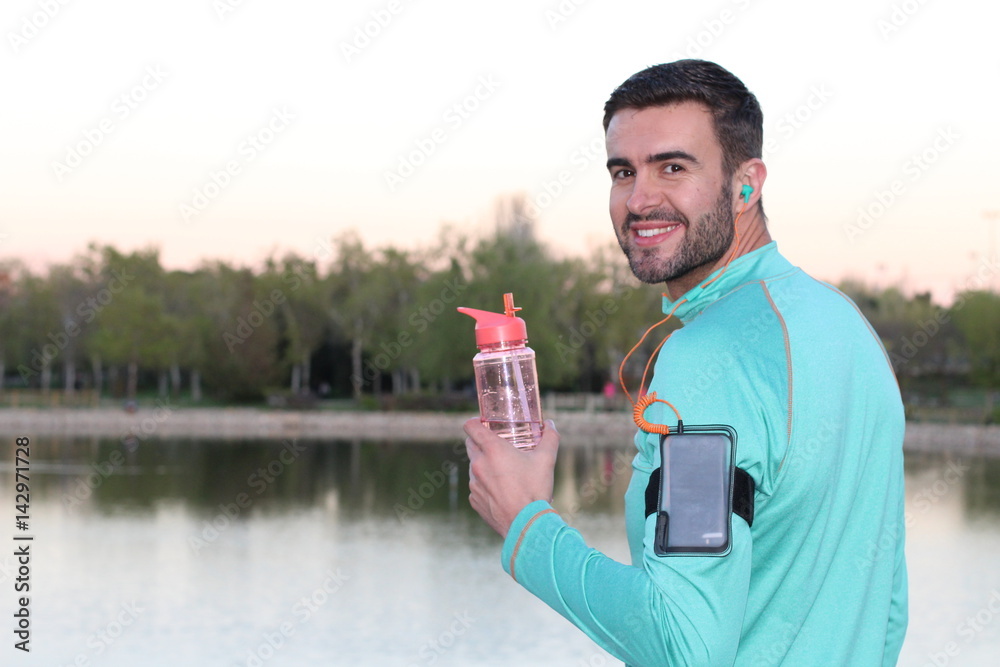 Refreshing with water break after jogging in the park - Stock image Refreshing with water break after jogging in the park - Stock image