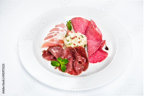 Dish of various types of meat-cutting on plate.