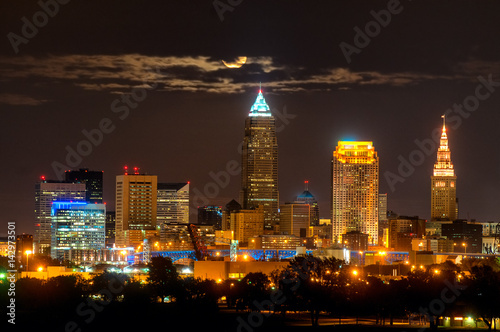 Rising full moon above Cleveland Ohio shining through clouds