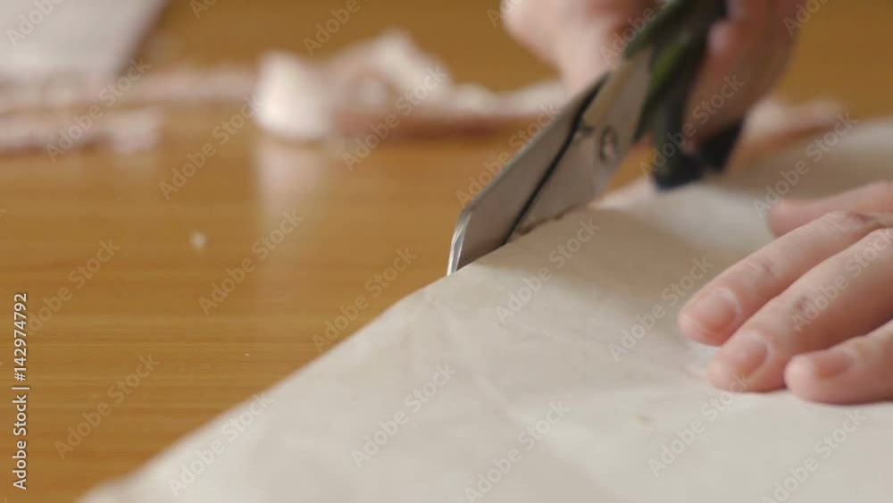 woman with tailor scissors or shears cutting out fabric at studio woman with tailor scissors or shears cutting out fabric at studio