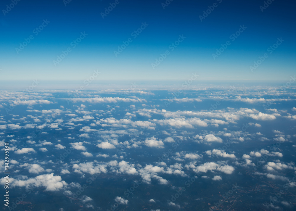Blue sky with white clouds, view from a flying airplane. Blue sky with white clouds, view from a flying airplane.