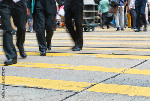 Busy city people on zebra crossing street in Hong Kong, China. © xy