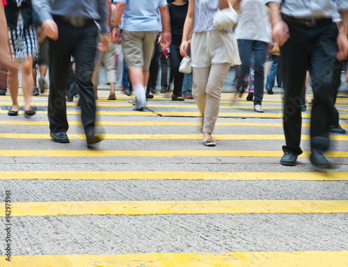 Busy city people on zebra crossing street in Hong Kong, China.