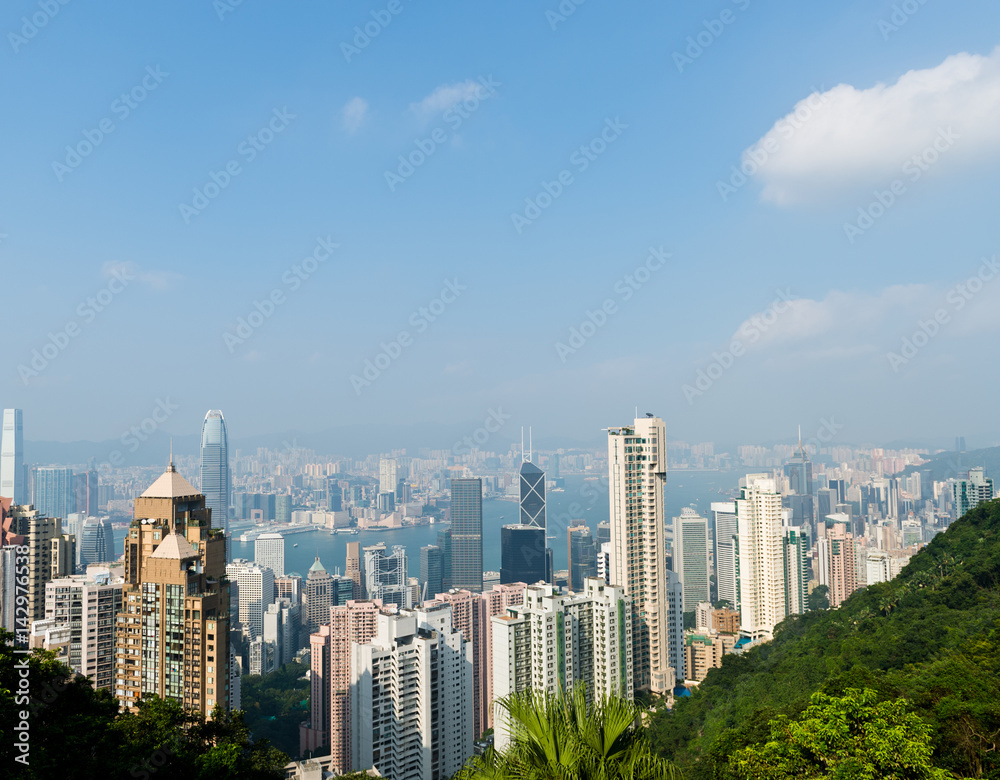Hong Kong cityscape with victoria harbour and large group of tall buildings.