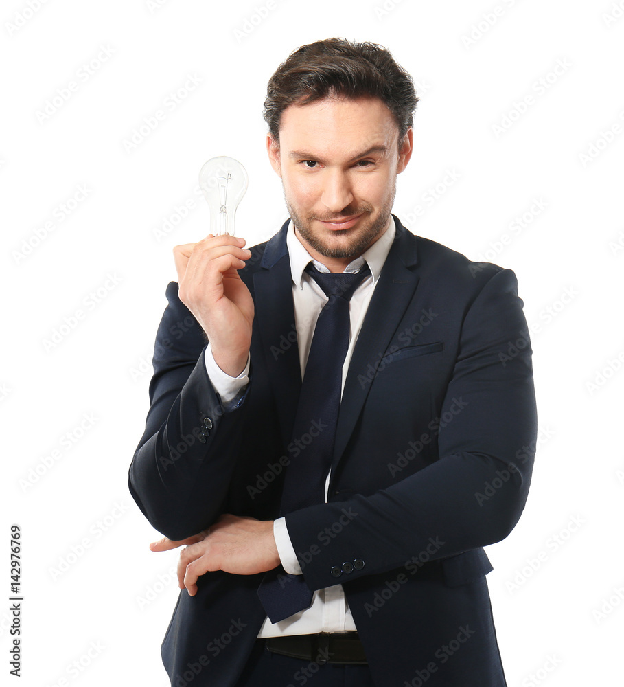 Handsome young man posing with lamp on white background Handsome young man posing with lamp on white background