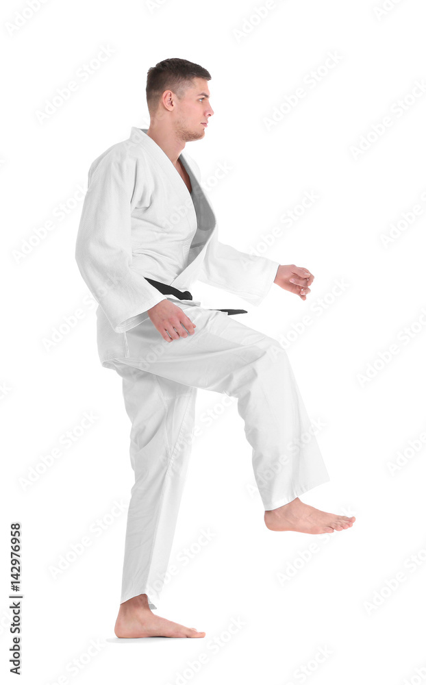 Young sporty man in kimono on white background Young sporty man in kimono on white background