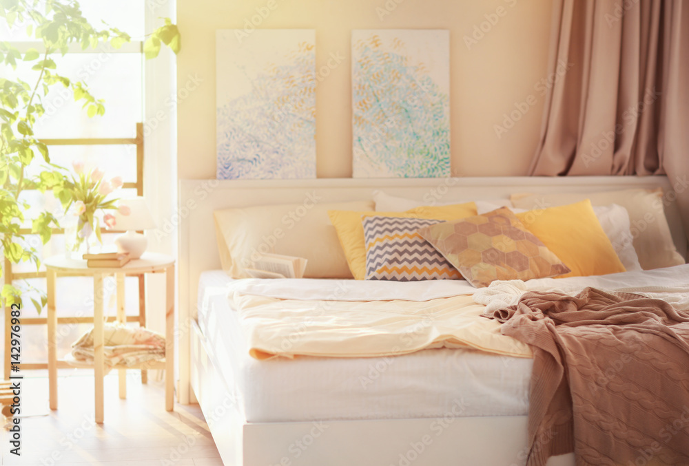 Interior of modern bedroom with cozy bed