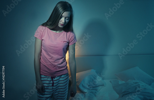 Young sleepy woman suffering from somnambulism at home