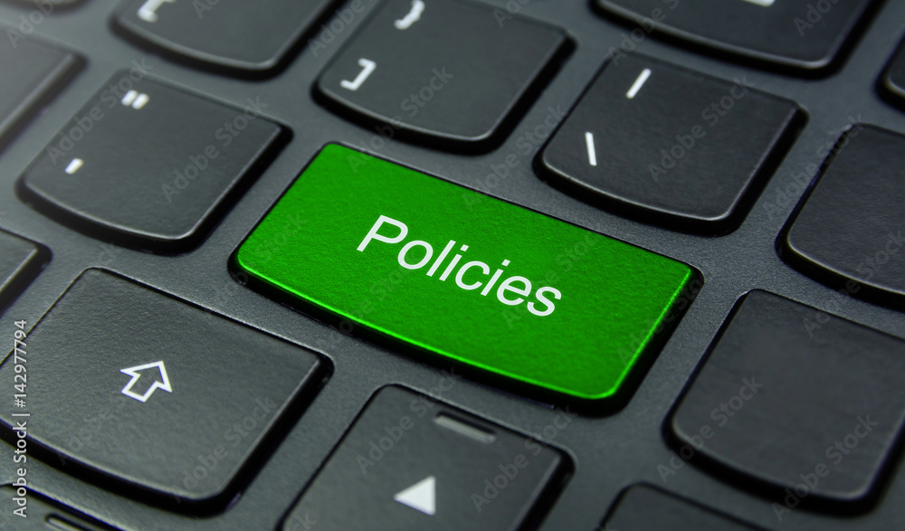 Close-up the Policies button on the keyboard and have Green color button isolate black keyboard Close-up the Policies button on the keyboard and have Green color button isolate black keyboard
