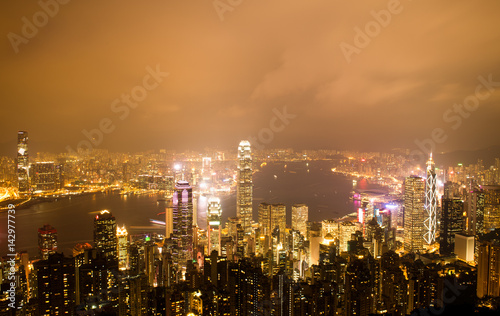 Hong Kong cityscape at night with victoria harbour and large group of tall buildings. © xy