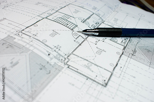 Architectural plan on the house plan with a pencil placed on 