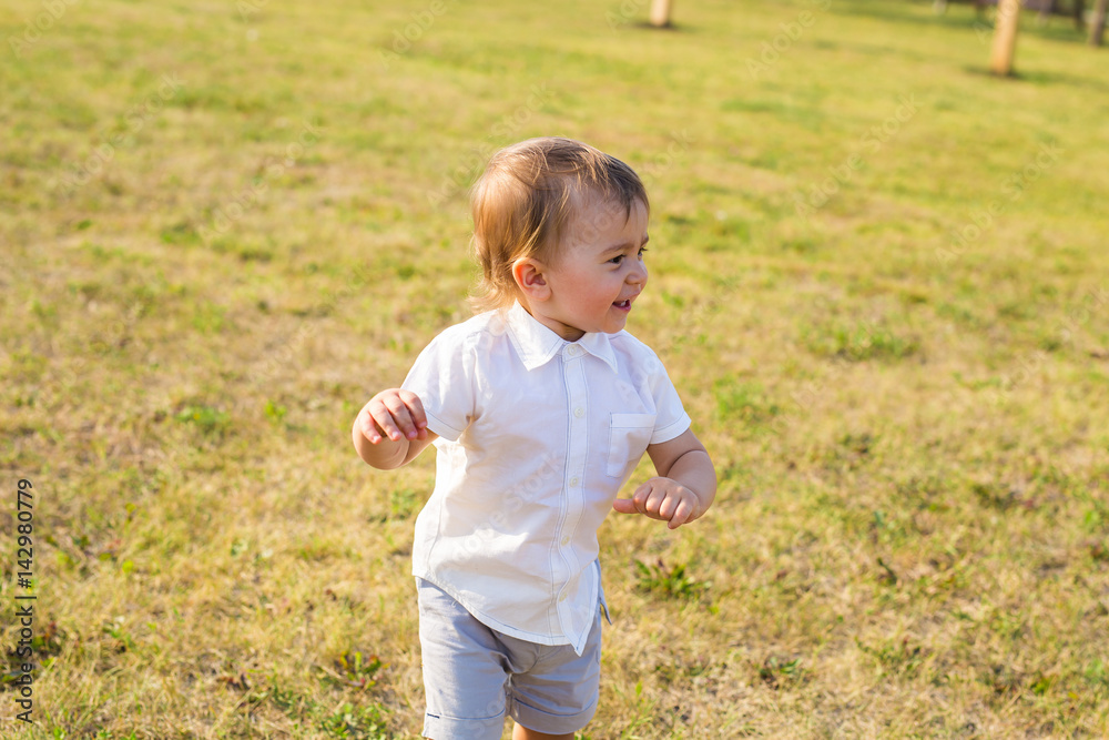 Portrait of smiling happy baby boy on natural background in summer Portrait of smiling happy baby boy on natural background in summer