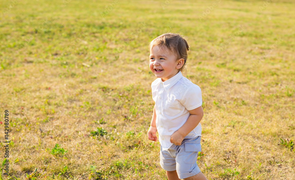 Portrait of smiling happy baby boy on natural background in summer Portrait of smiling happy baby boy on natural background in summer