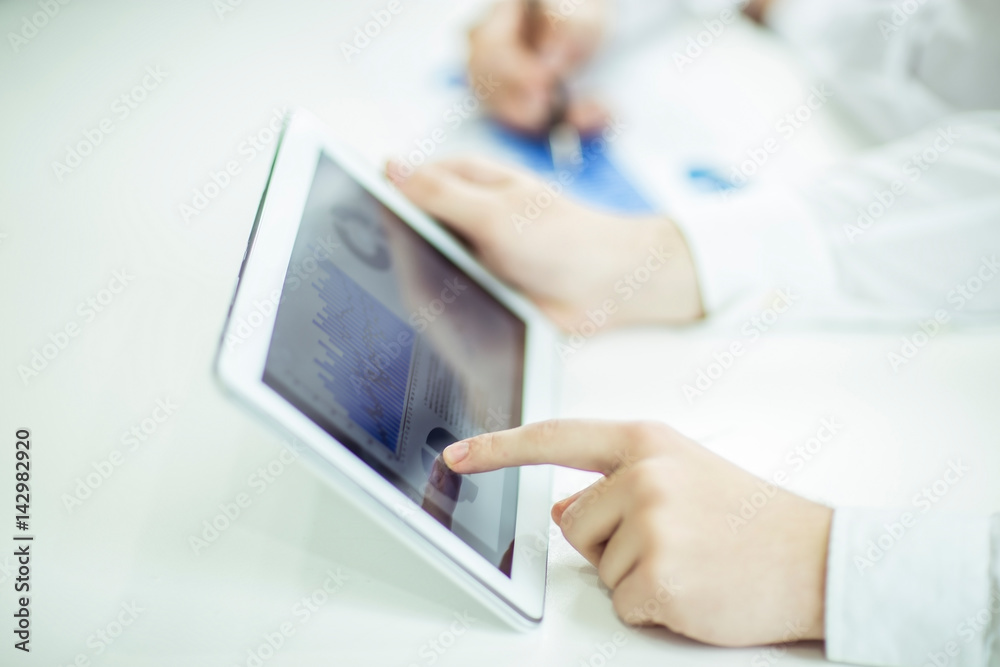 businessman using digital tablet, working with the financial schedule at the Desk businessman using digital tablet, working with the financial schedule at the Desk