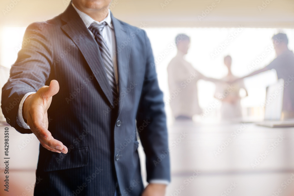 Businessman Offering Handshake in meeting room. Success Concept.