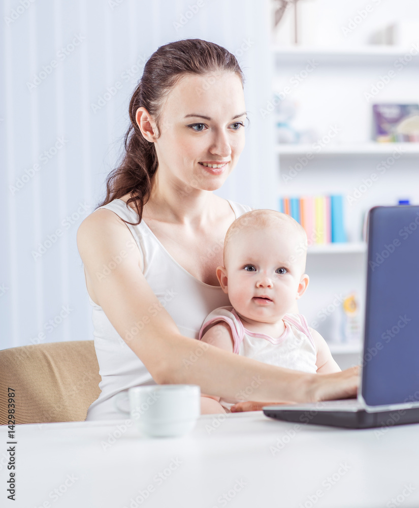 young mother and baby using laptop to communicate with grandma via skype young mother and baby using laptop to communicate with grandma via skype