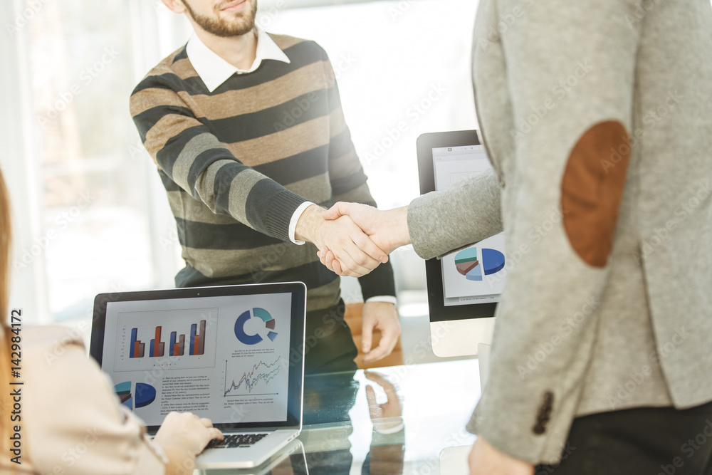 handshake between the client and the Manager of the company near the workplace handshake between the client and the Manager of the company near the workplace
