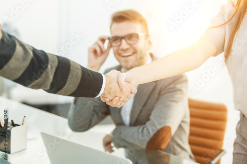 Fototapeta Naklejka Na Ścianę i Meble -  handshake of business partners on the background of the professional employee