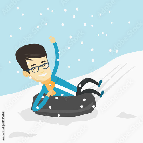 Man sledding on snow rubber tube in the mountains.