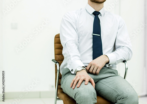 concept of business success - businessman sitting on a chair in 