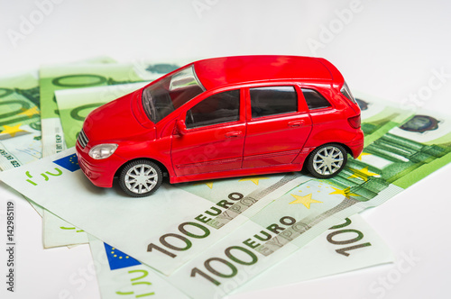 Toy car and euro money - insurance  rent and buying car