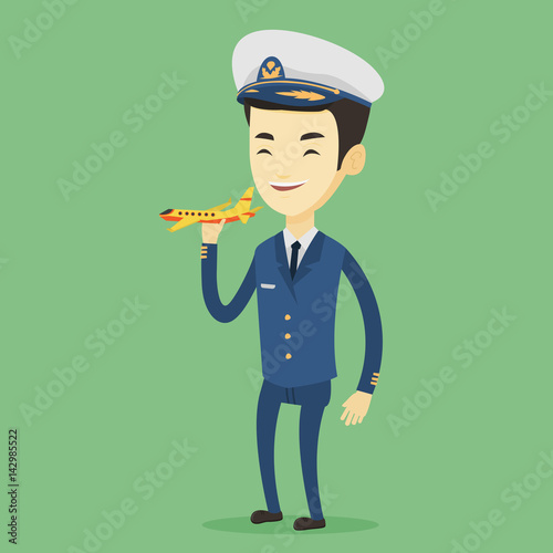 Cheerful airplane pilot with model of airplane.