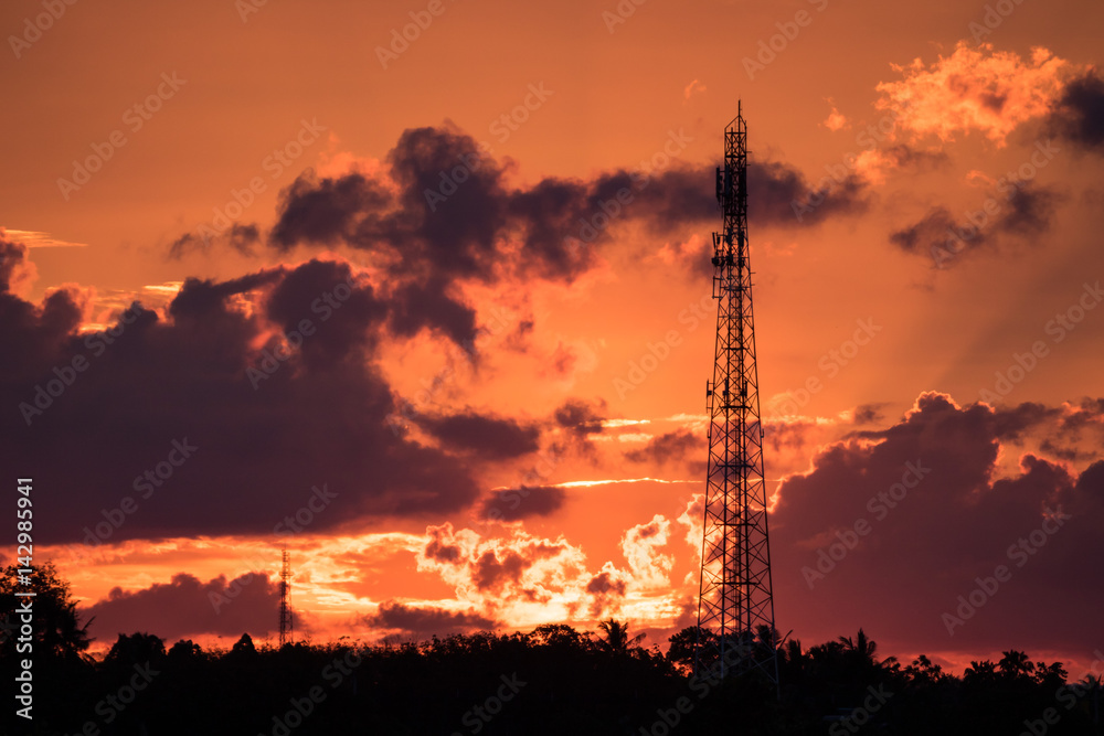  radio towers with sunset sky in background