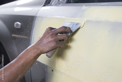 Auto body repair series : Applying putty filler photo