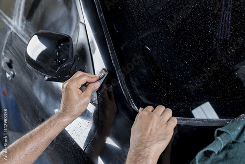 Auto body repair series : Closeup of hand wet-sanding car paint 