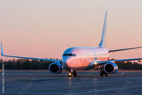 Taxiing aircraft in the morning crimson