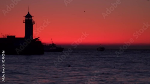 Wallpaper Mural Outlines of a mole with a lighthouse and a ship against the backdrop of dawn. Yalta Crimea Torontodigital.ca