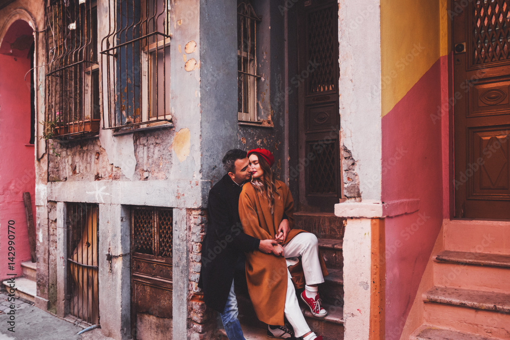 Happy couple in love on the background of old colorful painted facade. Old streets of Istanbul