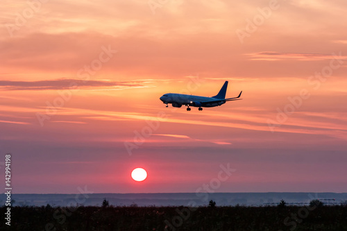 Aircraft landing at sunrise