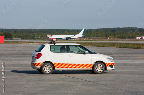 Follow me car is waiting aircraft on the airport apron